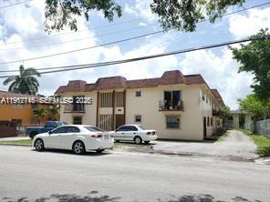 A two-story apartment building with a beige exterior and a brown shingled roof — 1008 NW 45th Ave # 9, Miami FL 33126, MIAMI, FL
