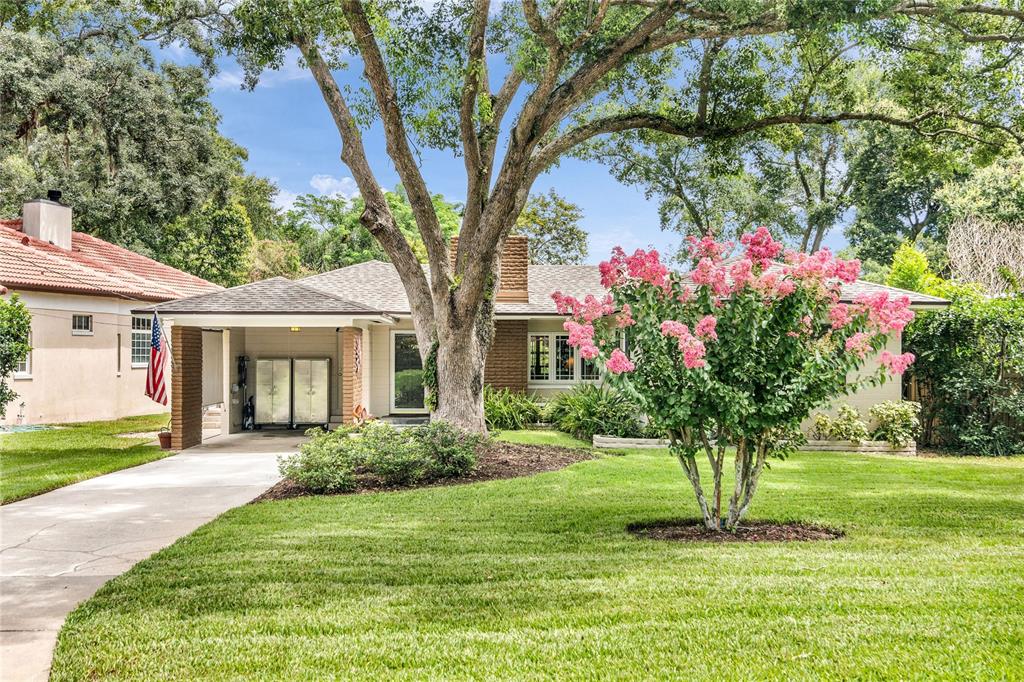 A single-story house with a carport, brick accents, and a blooming crape myrtle tree — 1215 DELANEY PARK DRIVE, ORLANDO, FL