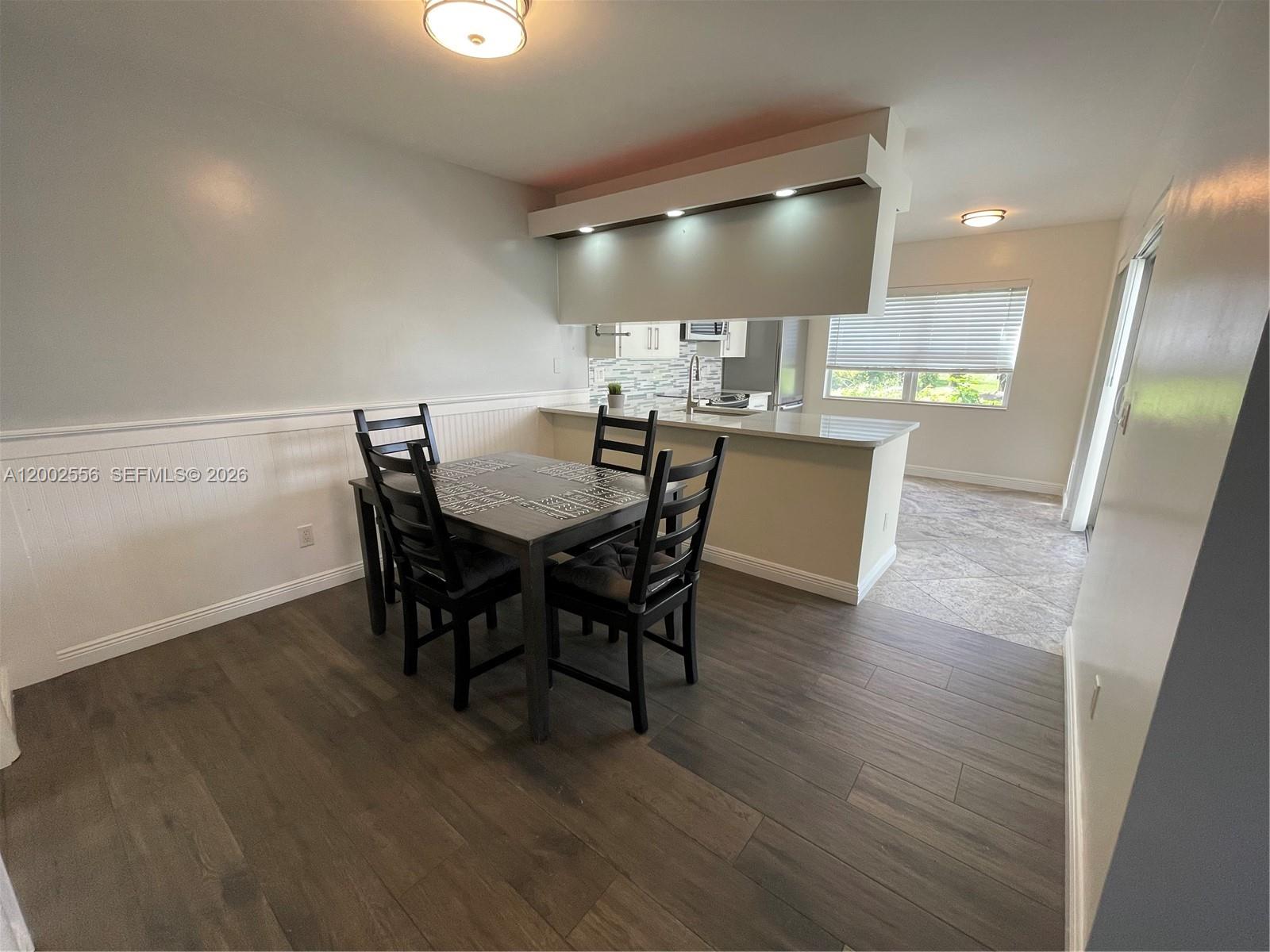 A living room features a dark leather sofa, two armchairs, and a central coffee table — 5801 Wheatley Ct, Boynton Beach FL 33436, BOYNTON BEACH, FL