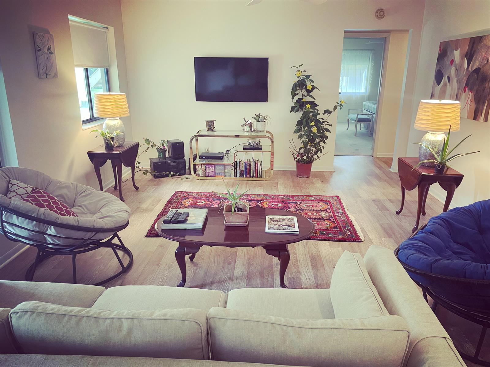 A living room features a beige sofa, two papasan chairs, a coffee table, and a rug — 519 Shady Pine Way # A2, FL 33415, FL