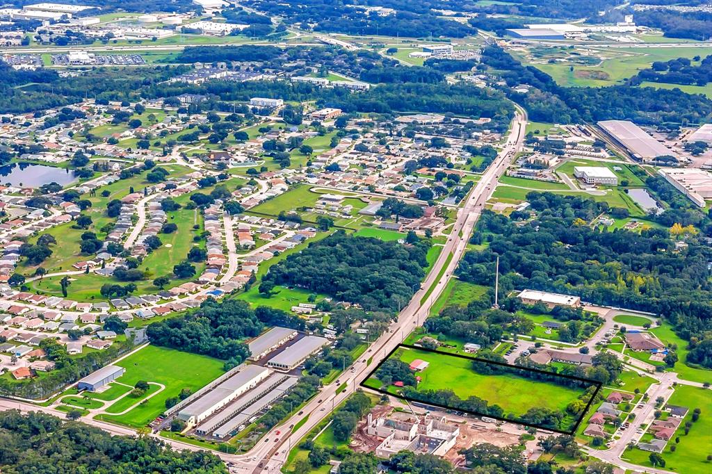 An aerial view shows a rectangular plot of land outlined in black near a highway — 3720 KATHLEEN ROAD, LAKELAND, FL