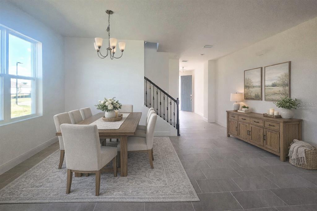 A dining room with a wooden table, chairs, chandelier, and a sideboard on tile flooring — 14574 CRESTAVISTA AVENUE, CLERMONT, FL