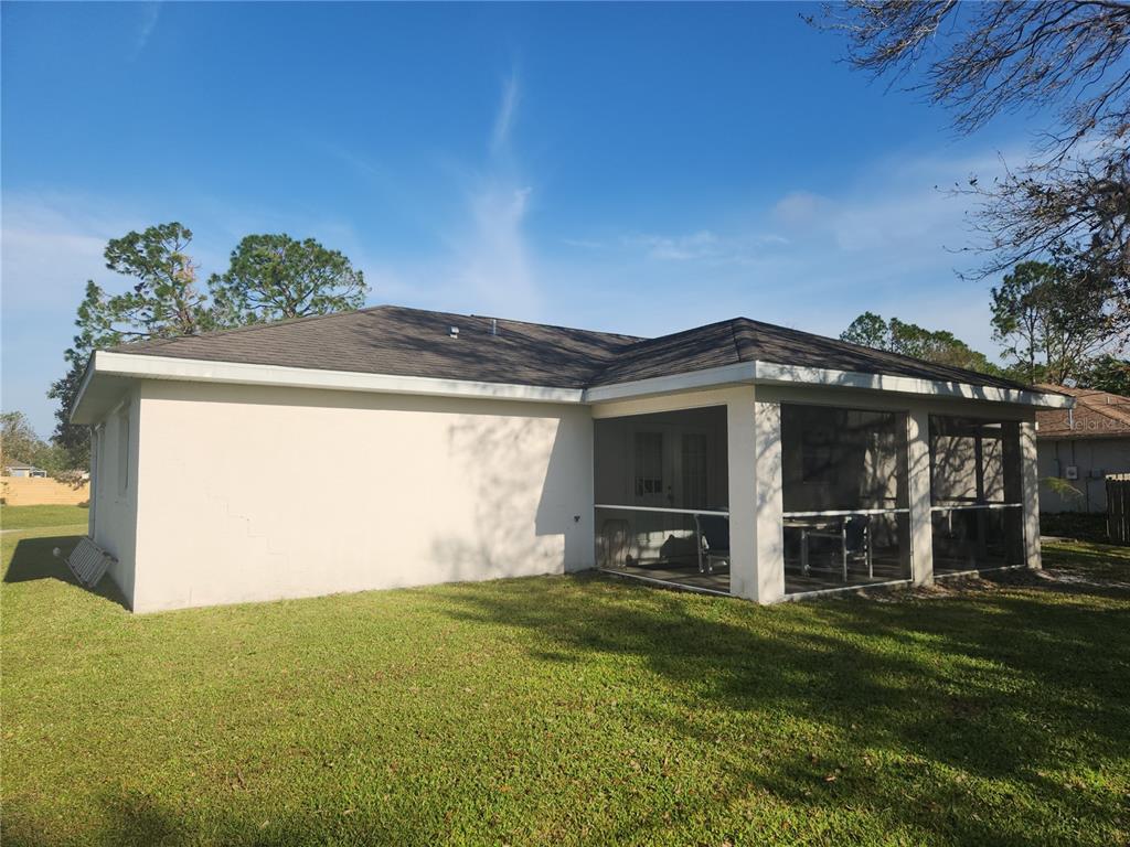An open-concept kitchen with wood-look tile flooring and French doors leading to the outdoors — 4254 CYNTHIA TERRACE, NORTH PORT, FL
