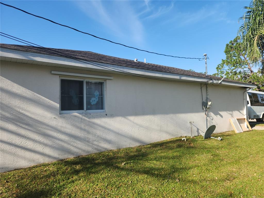 An empty bedroom features light wood-look flooring, white walls, and a ceiling fan — 4254 CYNTHIA TERRACE, NORTH PORT, FL