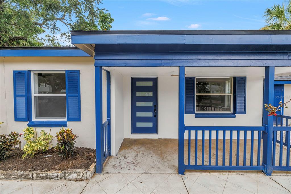 A front porch with a blue door, blue shutters, and a blue railing on a house — 8171 37TH AVENUE N, ST PETERSBURG, FL
