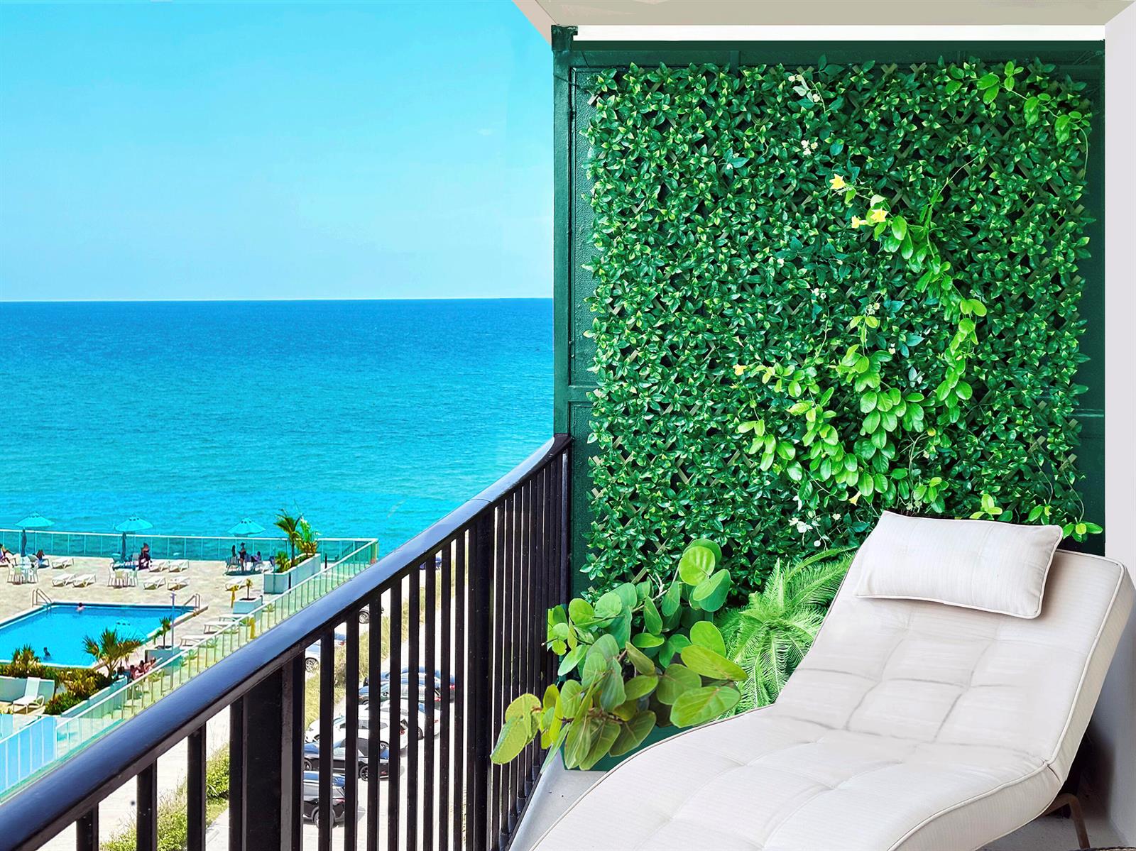 A balcony features a lounge chair, a green privacy screen, and a view of the ocean — 3460 S Ocean Boulevard # 7110, Palm Beach FL 33480, PALM BEACH, FL
