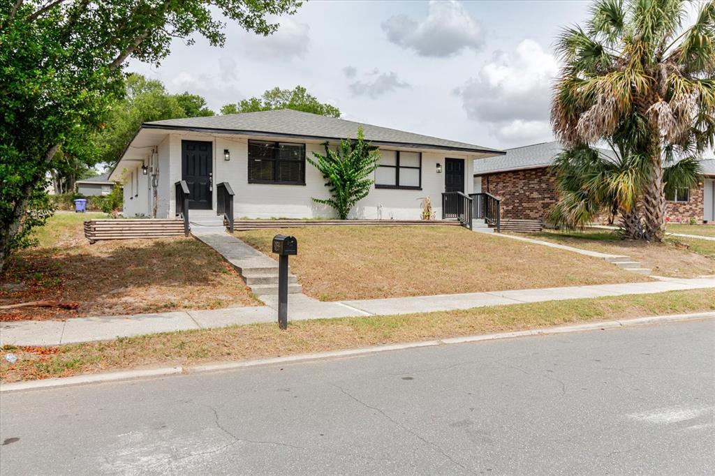 A single-story house with white siding, black trim, and two separate front entrances — 1134-1136 GILMORE AVENUE, LAKELAND, FL