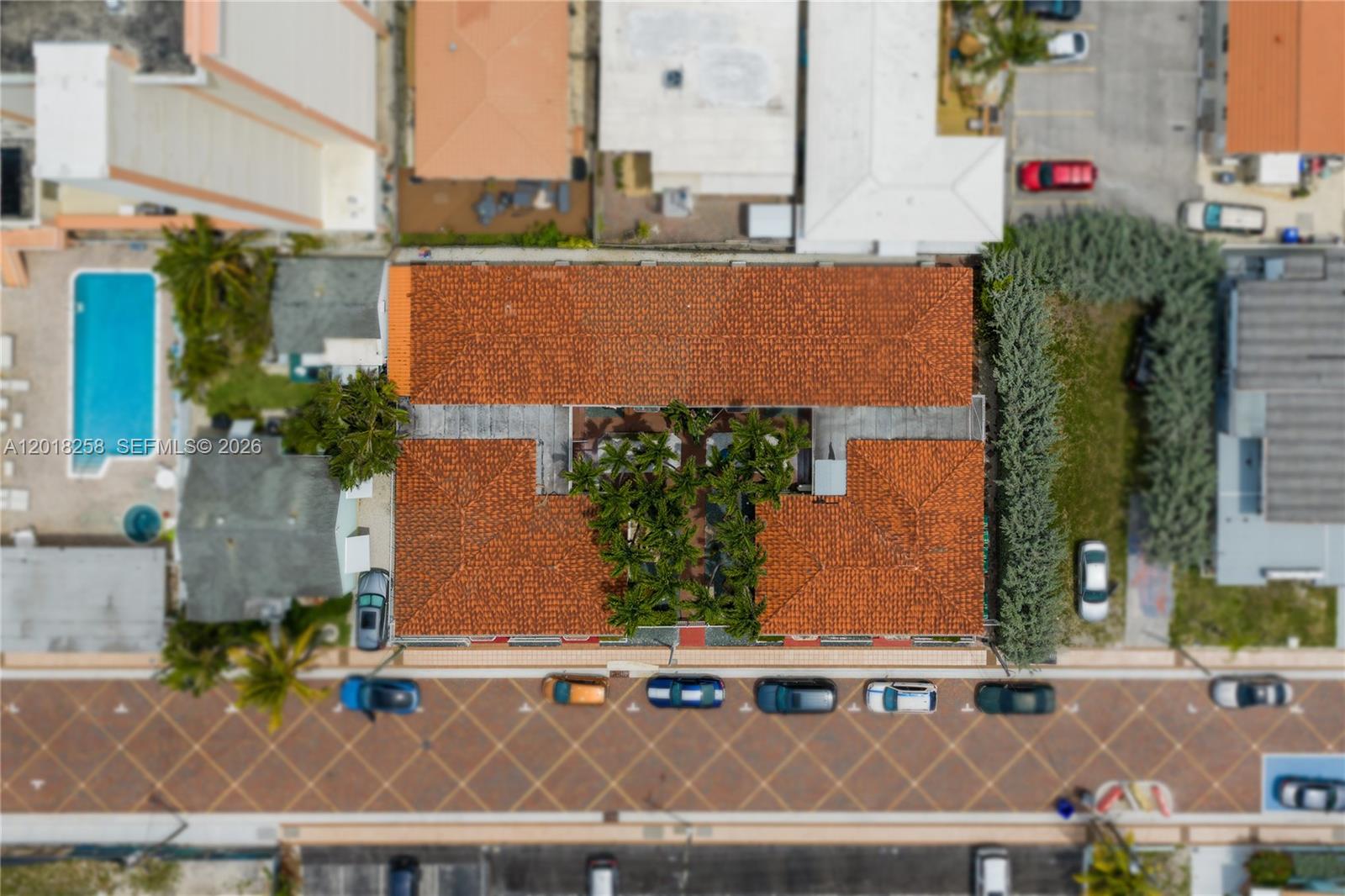 An aerial view shows a building with a red tile roof and a central courtyard — 335 Georgia St, Hollywood FL 33019, HOLLYWOOD, FL