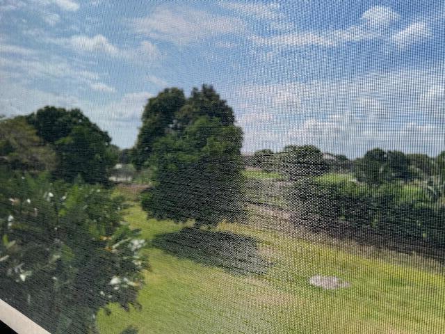 A view of a grassy yard and trees seen through a window screen — 6530 Boca Del Mar Drive # 337, Boca Raton FL 33433, BOCA RATON, FL