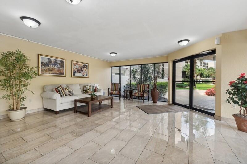 A lobby features a beige sofa, two armchairs, a coffee table, and glass entrance doors — 6530 Boca Del Mar Drive # 337, Boca Raton FL 33433, BOCA RATON, FL