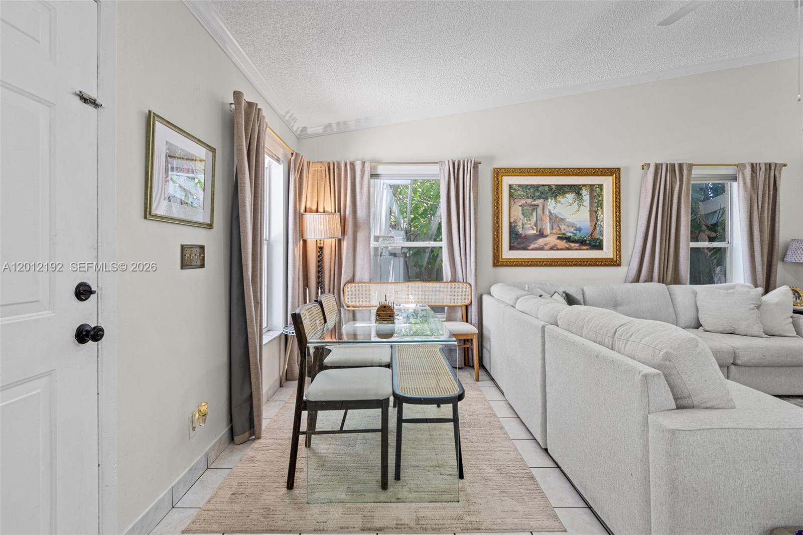 A living and dining area features a glass-topped table, upholstered chairs, and a sectional sofa — 5324 GRAY FOX CT, West Palm Beach FL 33415, WEST PALM BEACH, FL