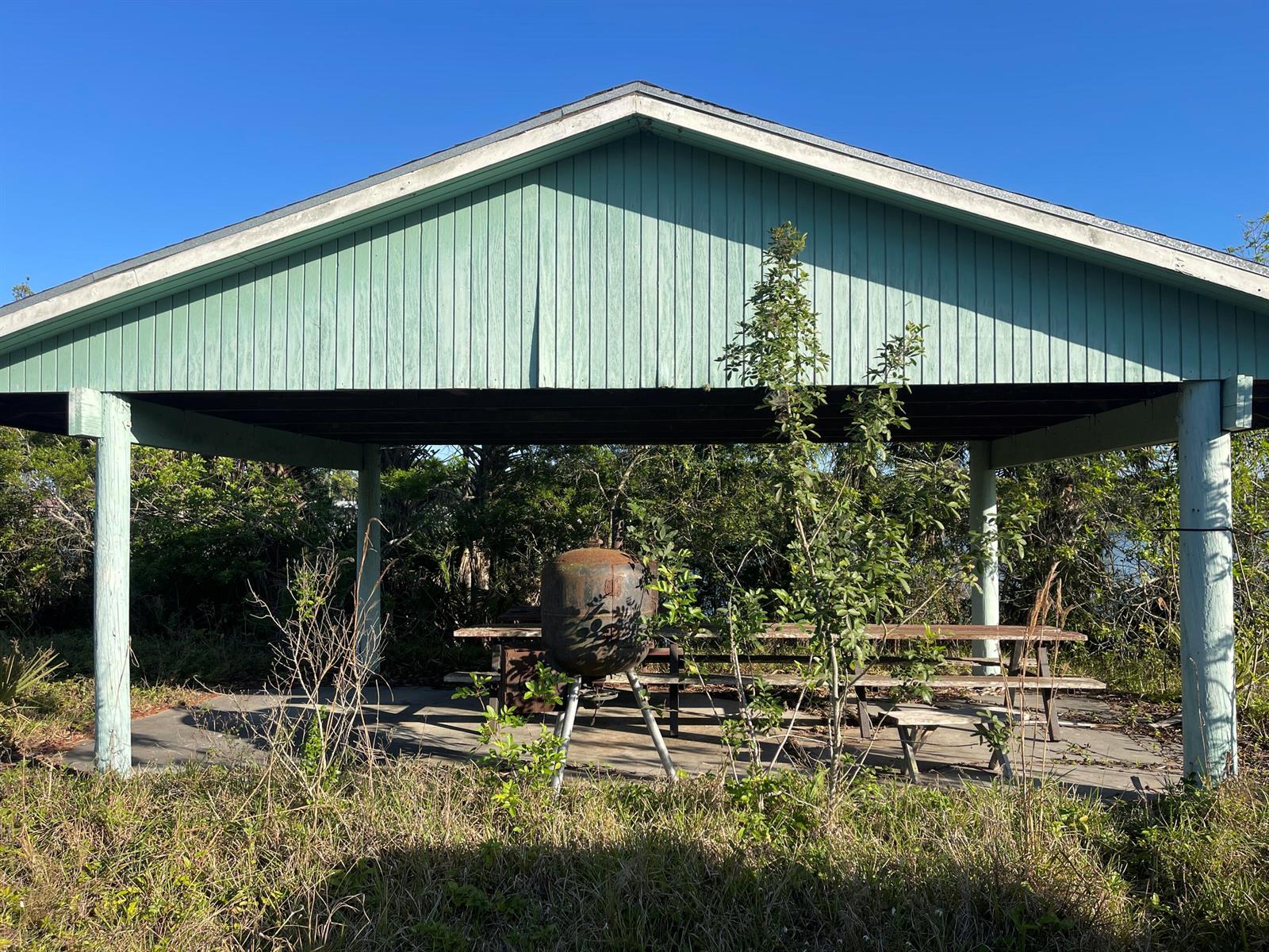 A light green pavilion with a picnic table and a rusted metal grill underneath — 265 State Rd 78, Moore Haven FL 33471, MOORE HAVEN, FL