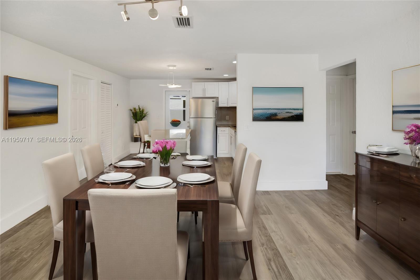 A bedroom features a bed with blue and white bedding, two nightstands, and two windows — 2311 Fletcher St, Hollywood FL 33020, HOLLYWOOD, FL