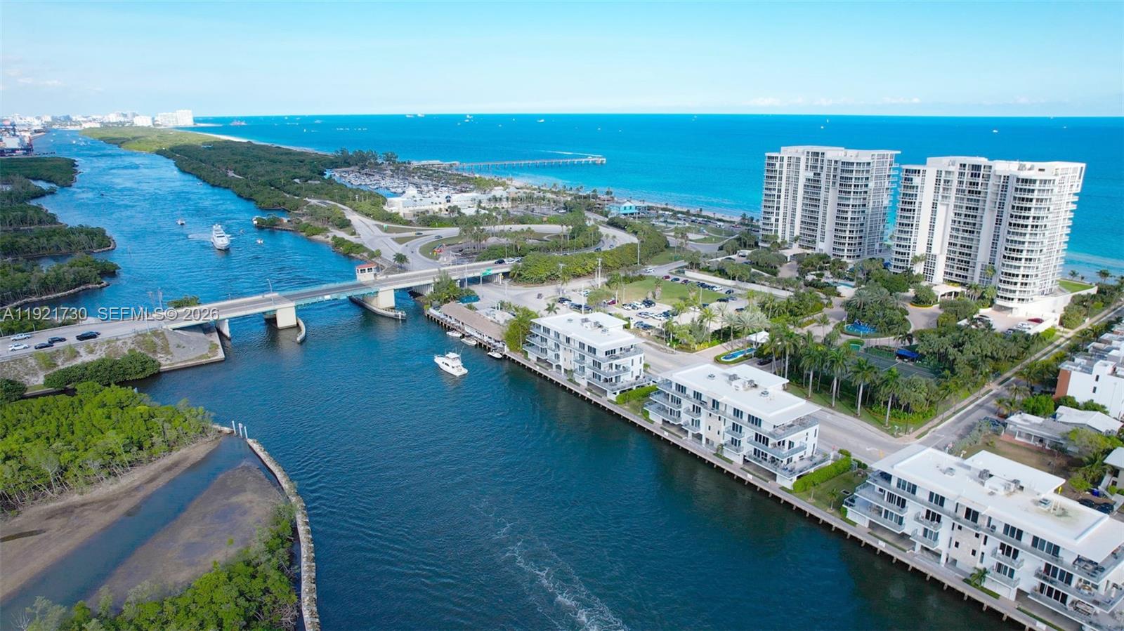 An aerial view shows a bridge, waterfront apartment buildings, and a coastal landscape — 6100 N Ocean Dr # 3N, Hollywood FL 33019, HOLLYWOOD, FL