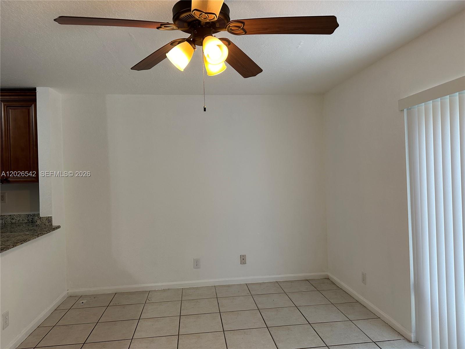 An empty dining area features white walls, a ceiling fan, and light-colored floor tiles — 824 Summit Lake, West Palm Beach FL 33406, WEST PALM BEACH, FL