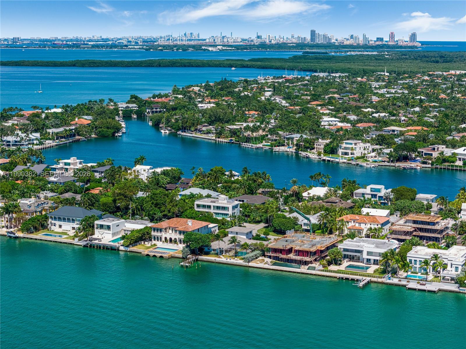 An aerial view shows waterfront luxury homes and a construction site along a canal — 640 S Mashta Dr, Key Biscayne FL 33149, KEY BISCAYNE, FL