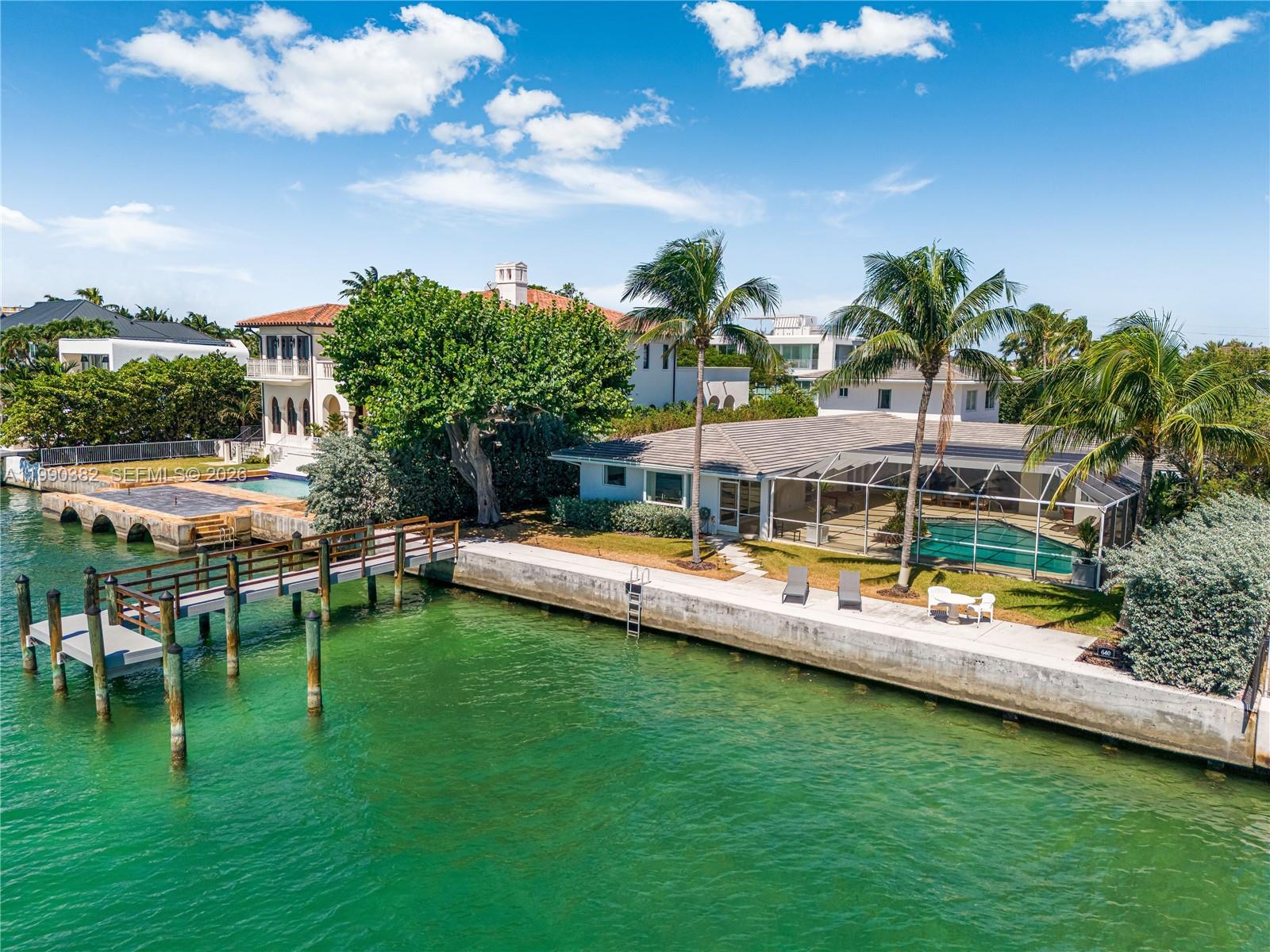 An aerial view shows a waterfront house with a pool, dock, and palm trees — 640 S Mashta Dr, Key Biscayne FL 33149, KEY BISCAYNE, FL