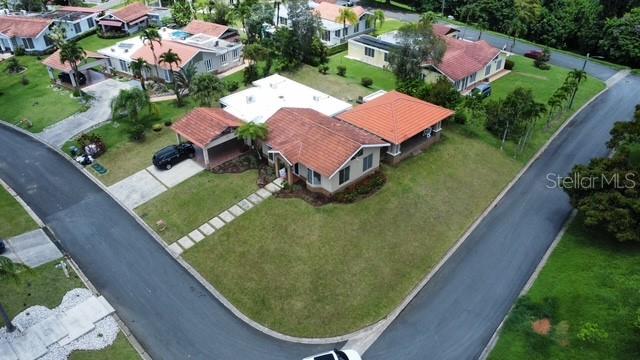 An aerial view shows a residential house with a red tile roof and surrounding lawns — 47 CAMINO DE LAS CASCADAS URB. SABANERA DE CIDRA, CIDRA, PR