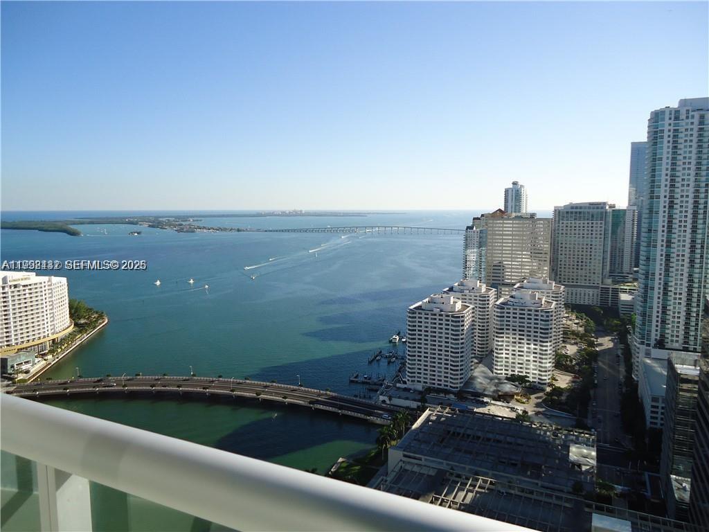 An elevated view of a bay with a bridge, boats, and surrounding high-rise buildings — 495 Brickell Ave # 3909, Miami FL 33131, MIAMI, FL