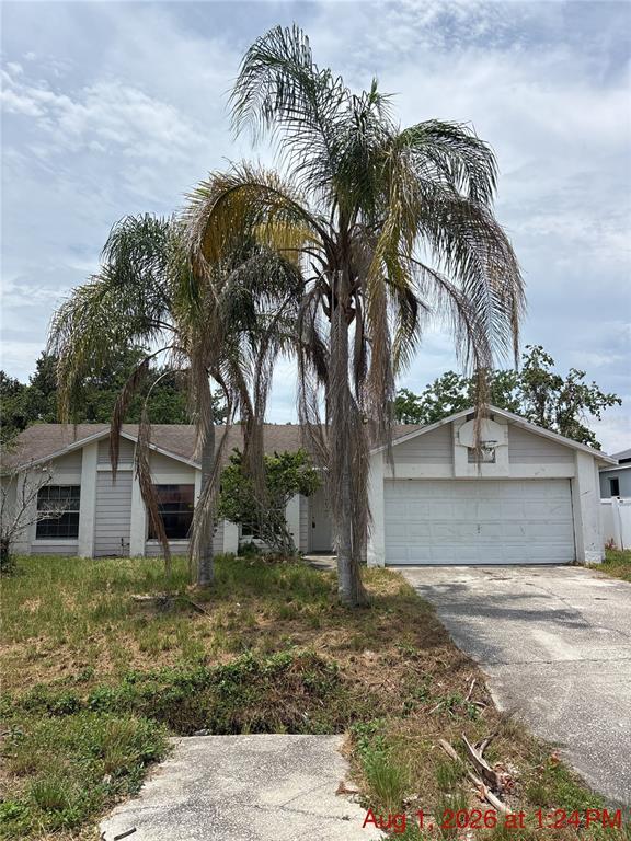A single-story house with a two-car garage and two tall palm trees in the front yard — 833 OGLETHORPE COURT, KISSIMMEE, FL