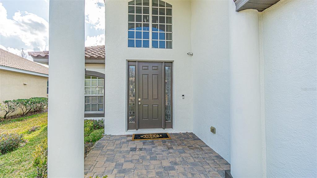 A two-story house with a tiled roof, a two-car garage, and a paved driveway — 10859 CORY LAKE DRIVE, TAMPA, FL