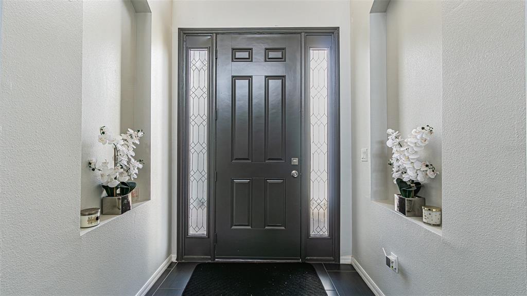 The front entrance features a dark door with sidelights, a stone porch, and white columns — 10859 CORY LAKE DRIVE, TAMPA, FL