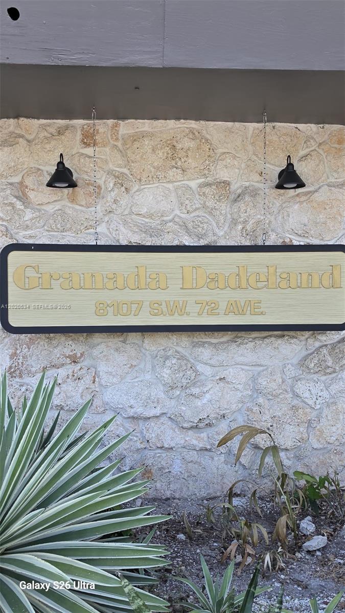 A sign reading Granada Dadeland hangs on a stone wall above some plants — 8107 SW 72nd Ave # 423E, Miami FL 33143, MIAMI, FL