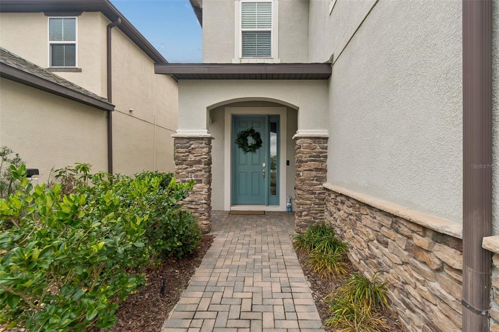 A covered patio with a dining set, ceiling fans, and a screened-in view of a pond — 11512 NAVEL ORANGE WAY, TAMPA, FL