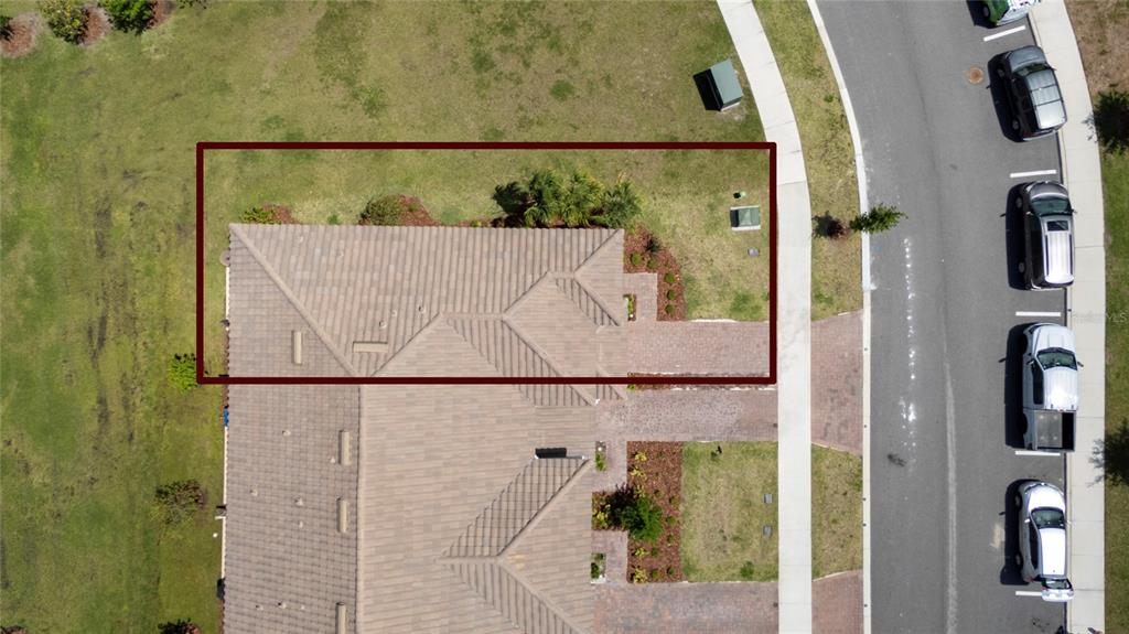 An aerial view shows a residential house roof and a portion of the front yard — 3635 MAIN HARBOR DRIVE, KISSIMMEE, FL