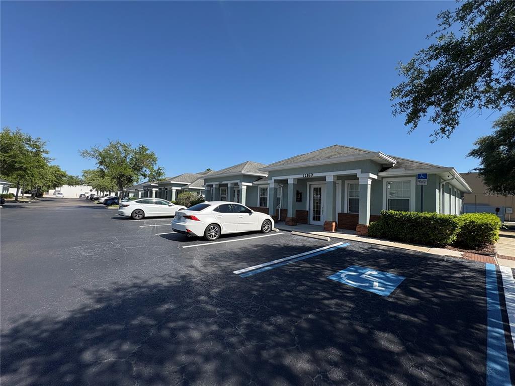 A single-story commercial building with a parking lot and a designated handicap space — 12187-12189 W LINEBAUGH AVENUE, TAMPA, FL