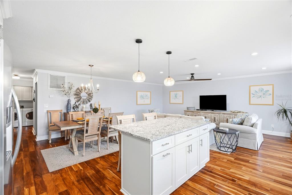 A kitchen with white cabinets, granite countertops, stainless steel appliances, and hardwood flooring — 6190 80TH STREET N UNIT 403, ST PETERSBURG, FL