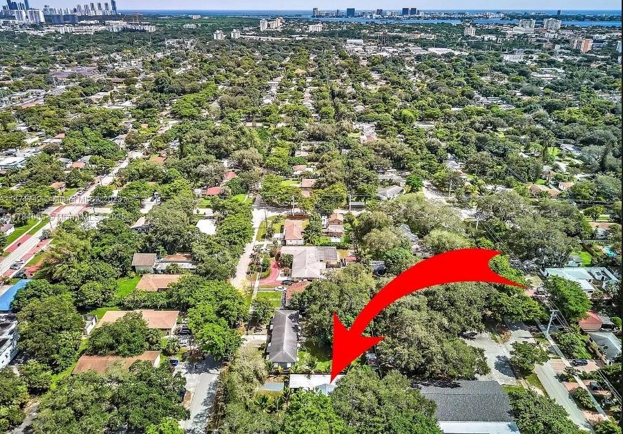 An aerial view shows a residential property with a red arrow pointing to a house — 936 NE 132nd St, North Miami FL 33161, NORTH MIAMI, FL