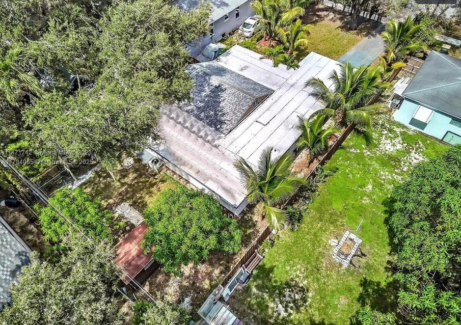 An aerial view shows a house with a flat roof, surrounding trees, and a grassy yard — 936 NE 132nd St, North Miami FL 33161, NORTH MIAMI, FL