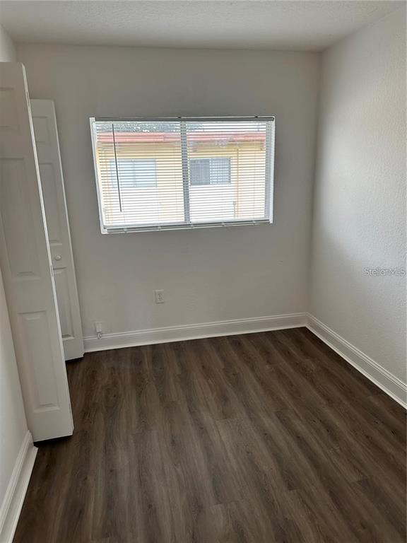 A small room with wood-look flooring, white walls, a window with blinds, and a closet — 778 RIDENHOUR CIRCLE UNIT 778, ORLANDO, FL