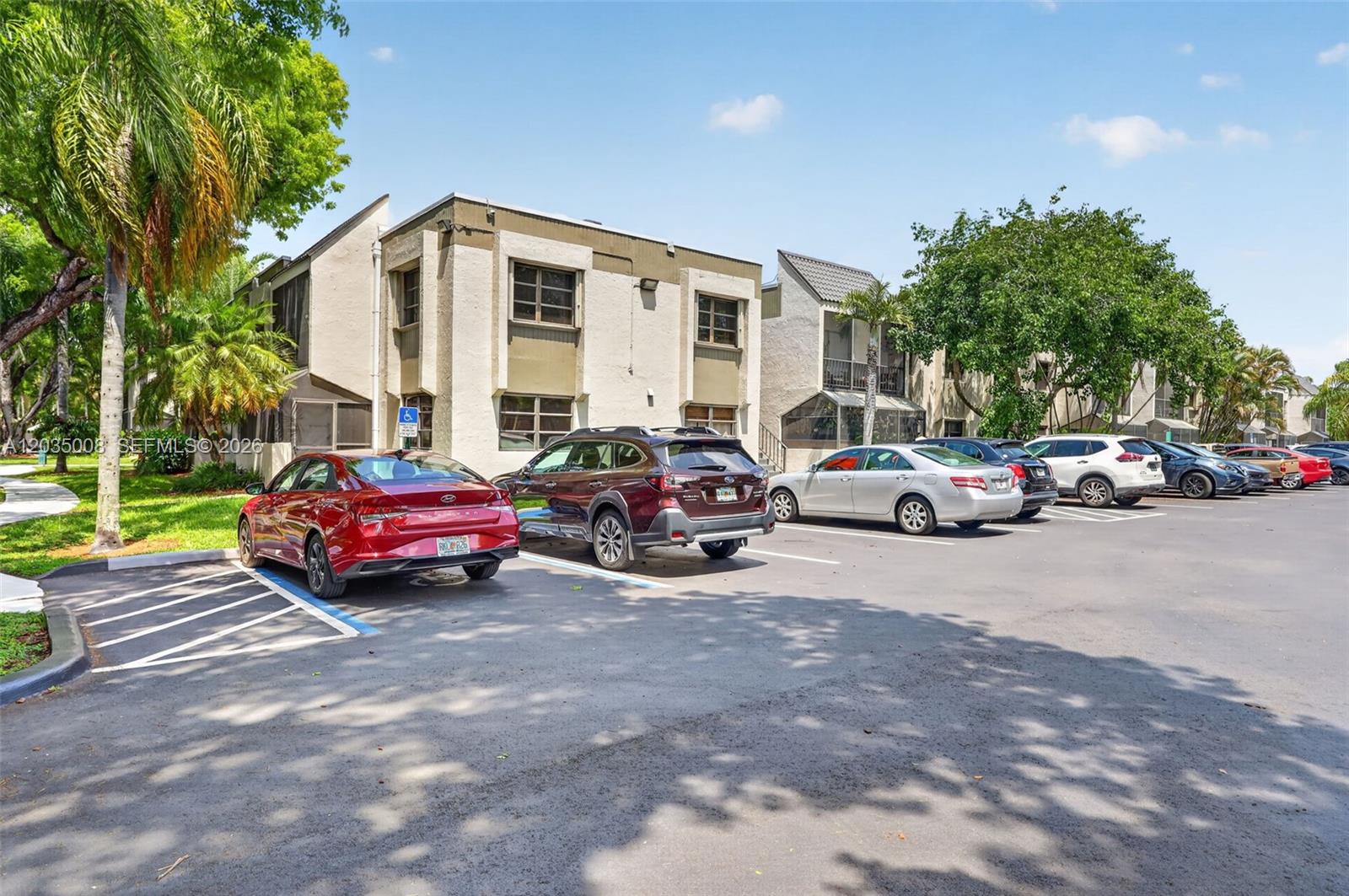 A multi-story apartment building with a parking lot in the foreground — 7917 SW 104th St # 201F, Miami FL 33156, MIAMI, FL