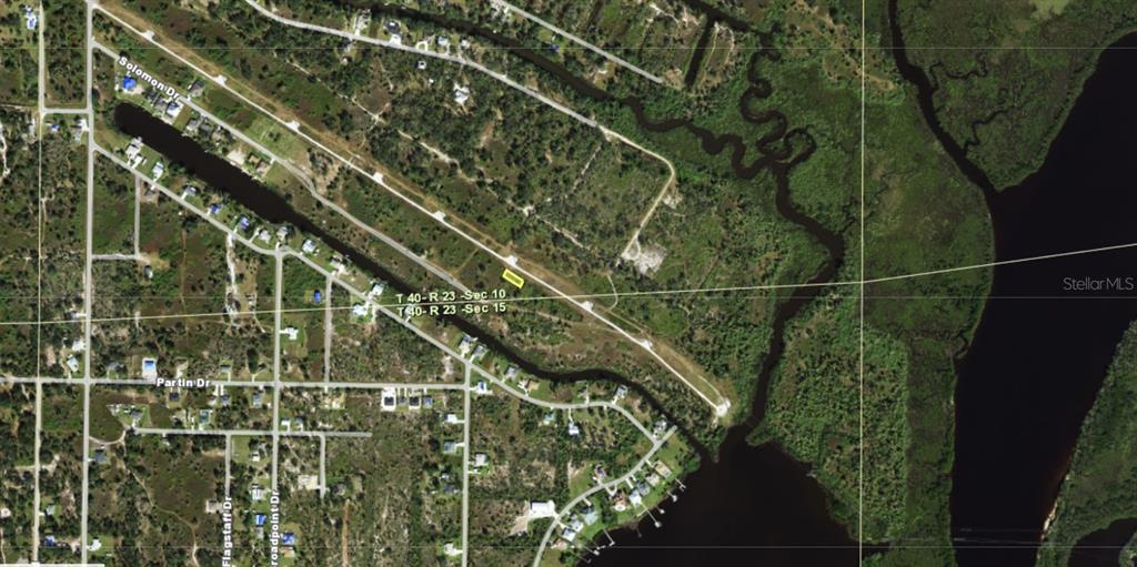 An aerial map view shows a highlighted parcel of land near a waterway and roads — 1514 PALSGRAVE DRIVE, PUNTA GORDA, FL