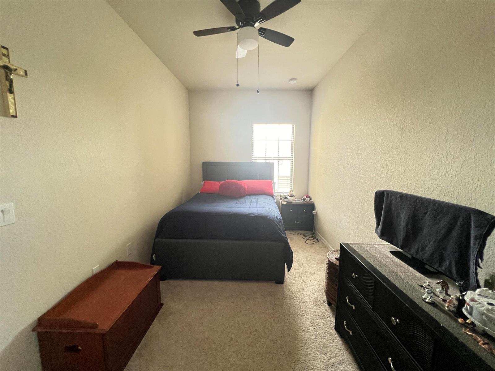 A beige townhouse exterior features a dark blue front door, brown garage, and paved walkway — 4843 Indio Trail, Lake Worth FL 33467, LAKE WORTH, FL