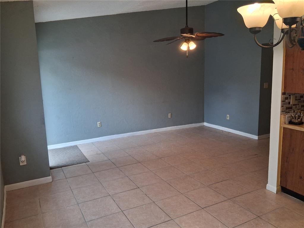 A dining room with gray walls, tile flooring, and a ceiling fan — 1977 SW 69TH DRIVE, GAINESVILLE, FL