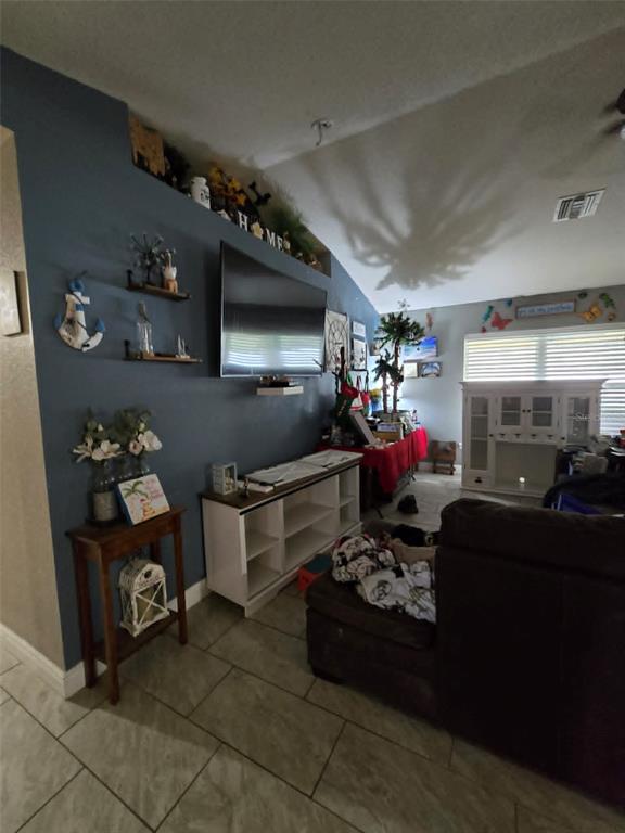 A single-story house with a beige exterior and a two-car garage sits on a lot — 1982 WINSLOW LANE, NORTH PORT, FL