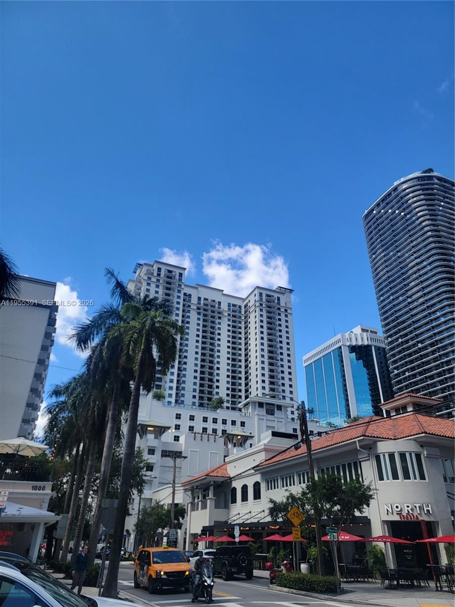 A street-level view shows a city intersection with tall residential buildings and a restaurant — 999 SW 1st Ave # 2302, Miami FL 33130, MIAMI, FL