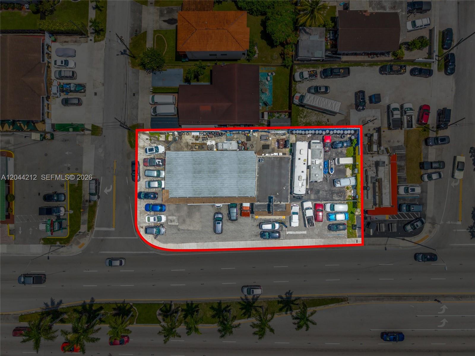 This aerial view shows a commercial property with a building and parking lot outlined in red — 8765 Bird Rd, Miami FL 33165, MIAMI, FL