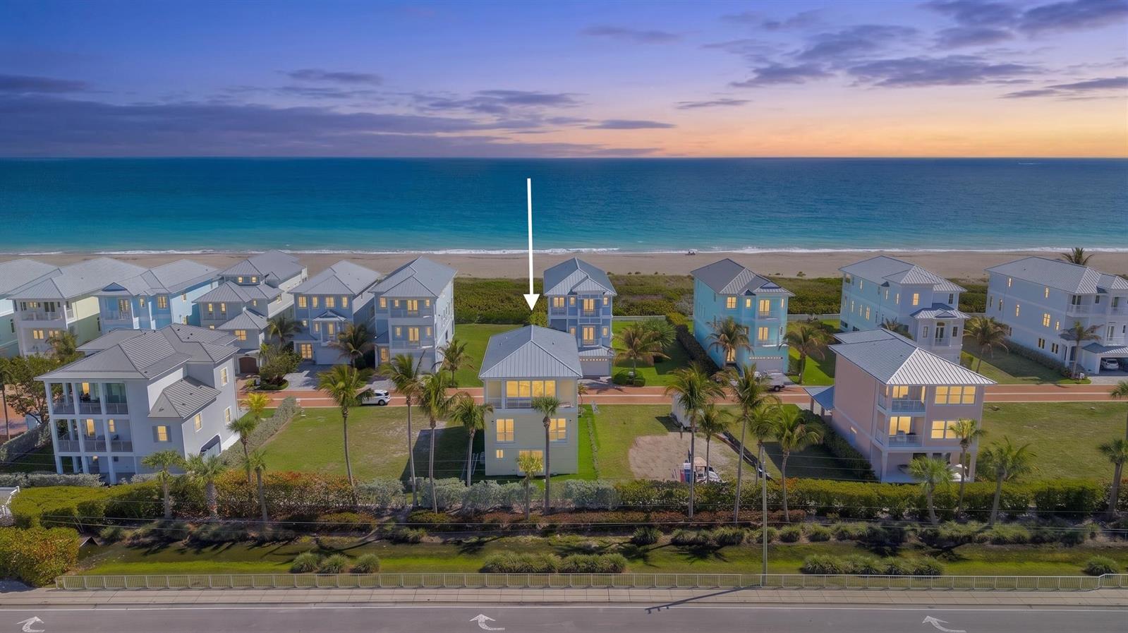 An aerial view shows a row of beach houses along the ocean at sunset — 4857 Watersong Way, Fort Pierce FL 34949, FORT PIERCE, FL
