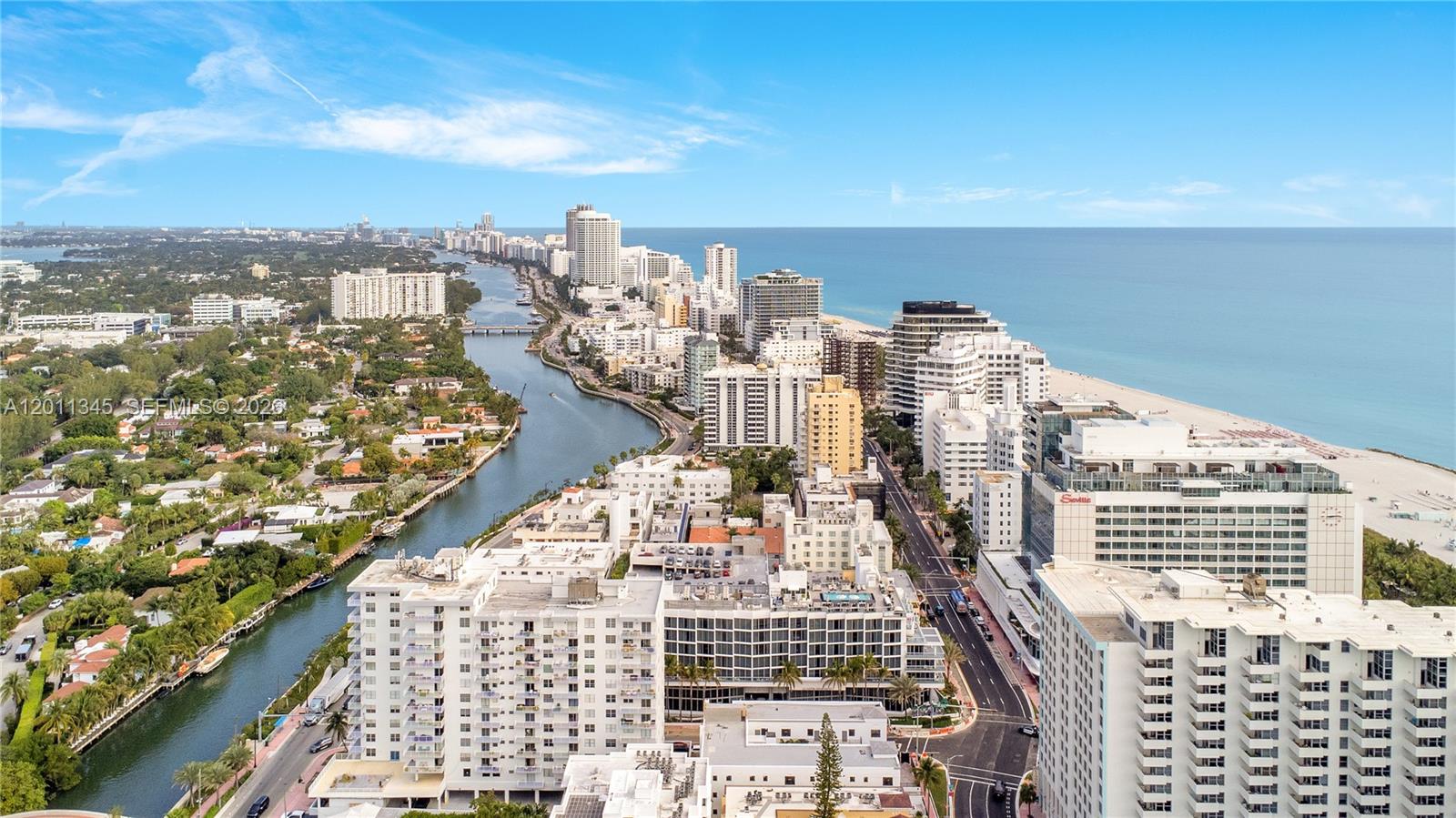 An aerial view shows a coastal city with high-rise buildings, a waterway, and the ocean — 2814 Collins Ave, Miami Beach FL 33140, MIAMI BEACH, FL