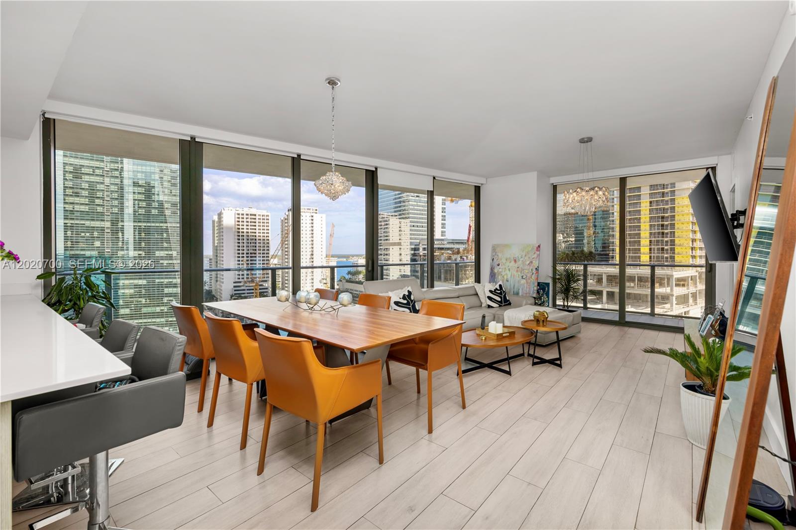 A modern living and dining area with floor-to-ceiling windows overlooking a city skyline — 1300 S Miami Ave # 1405, Miami FL 33130, MIAMI, FL