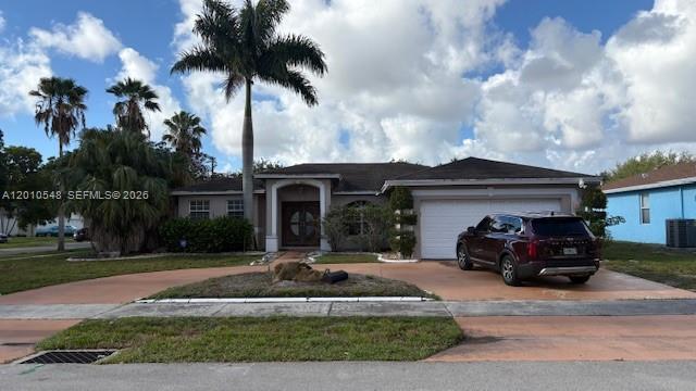 A single-story house with a brown roof, a palm tree, and a car in the driveway — 774 NW 16th Pl, Pompano Beach FL 33060, POMPANO BEACH, FL
