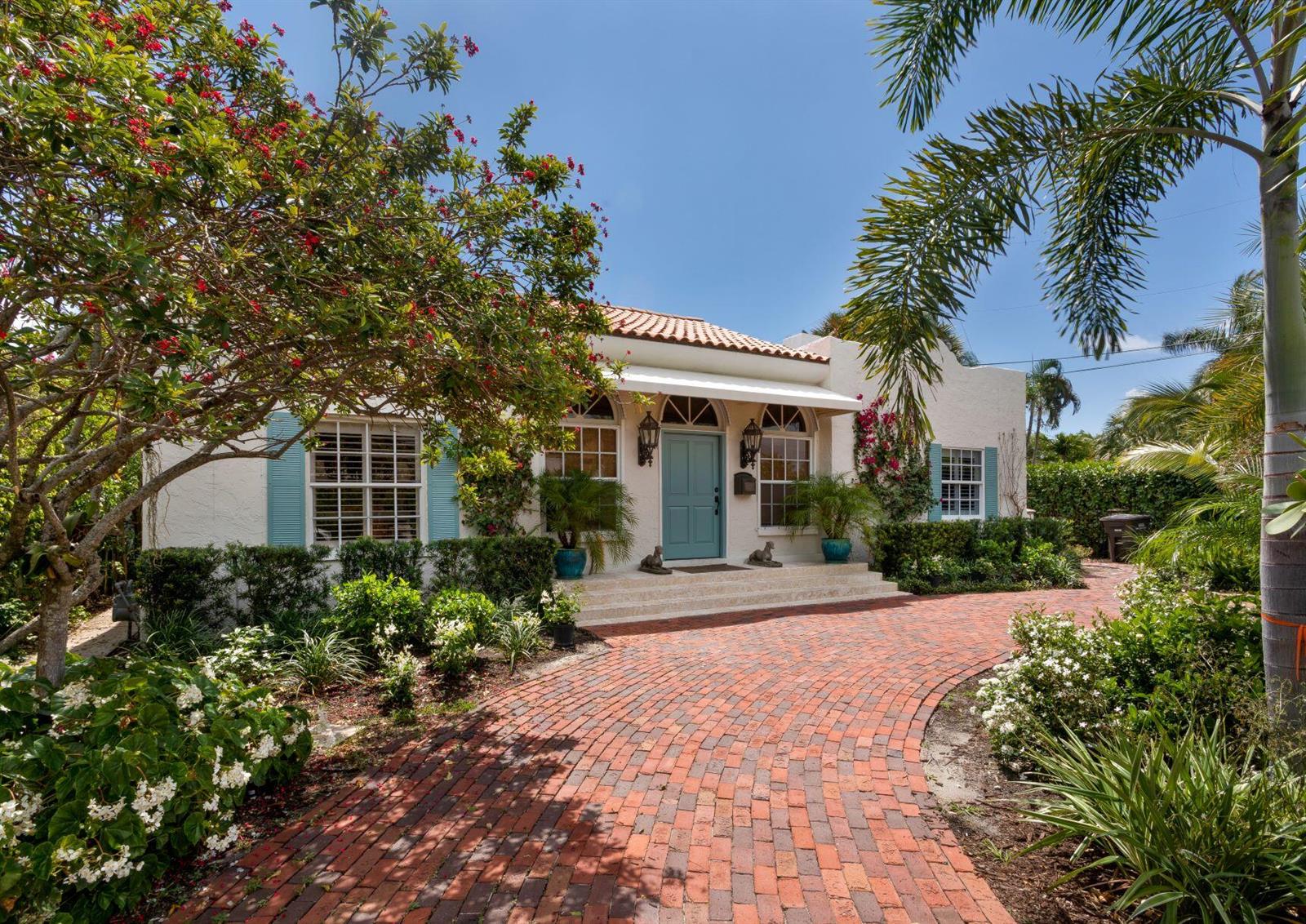 A single-story stucco house with a brick driveway, blue shutters, and a teal front door — 4210 Washington Road, West Palm Beach FL 33405, WEST PALM BEACH, FL