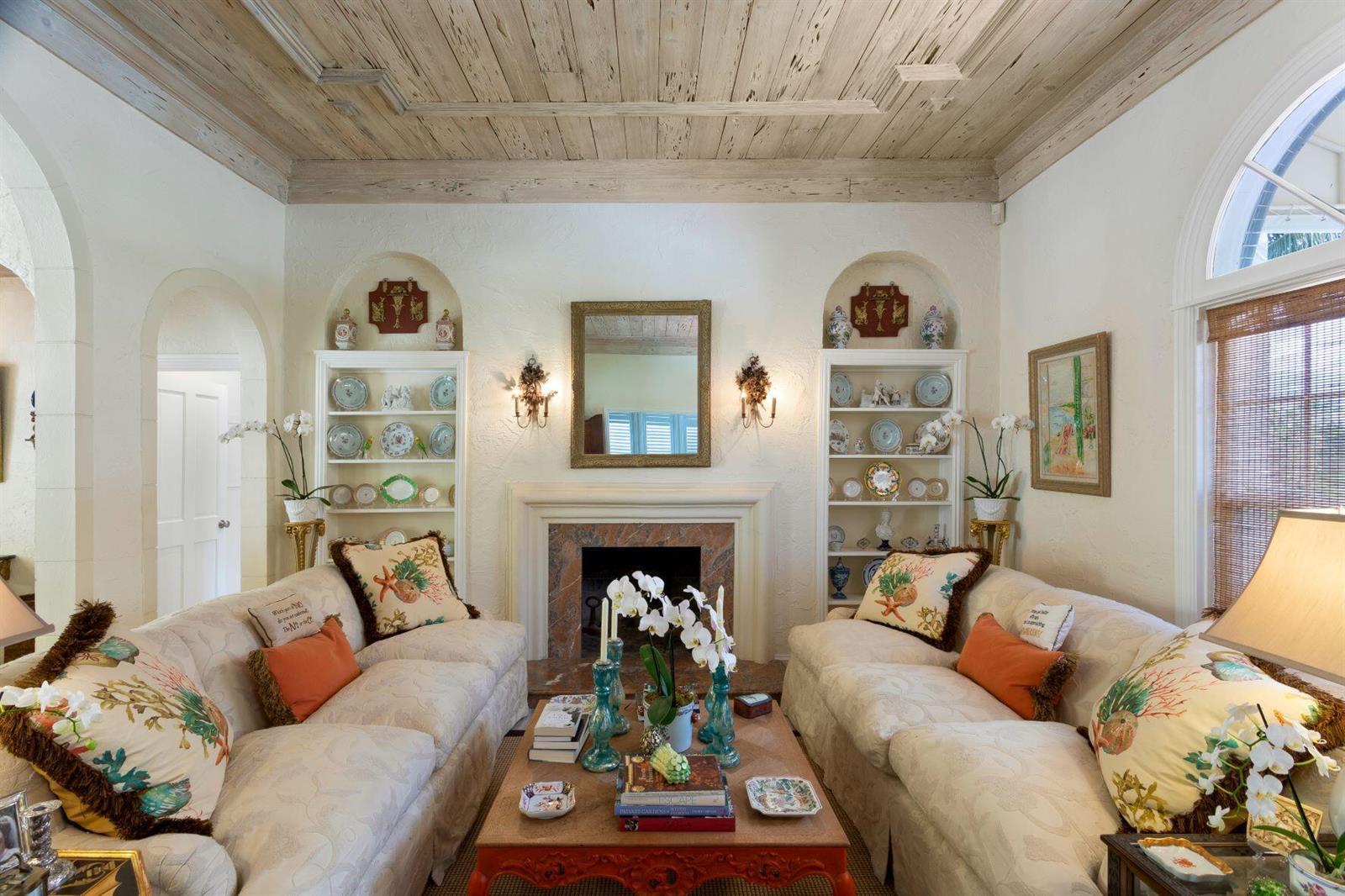 A living room features two sofas, a fireplace, built-in shelving, and a wood-plank ceiling — 4210 Washington Road, West Palm Beach FL 33405, WEST PALM BEACH, FL