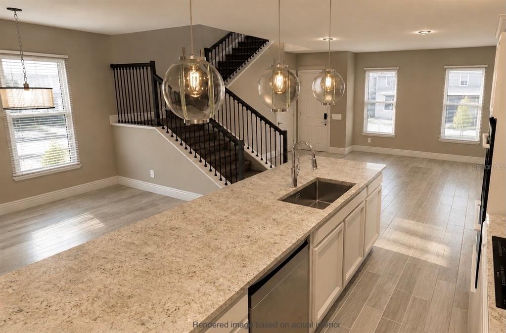 This is a rendering of a kitchen with a granite island and a staircase — 10301 AUSTRINA OAK LOOP, WINTER GARDEN, FL