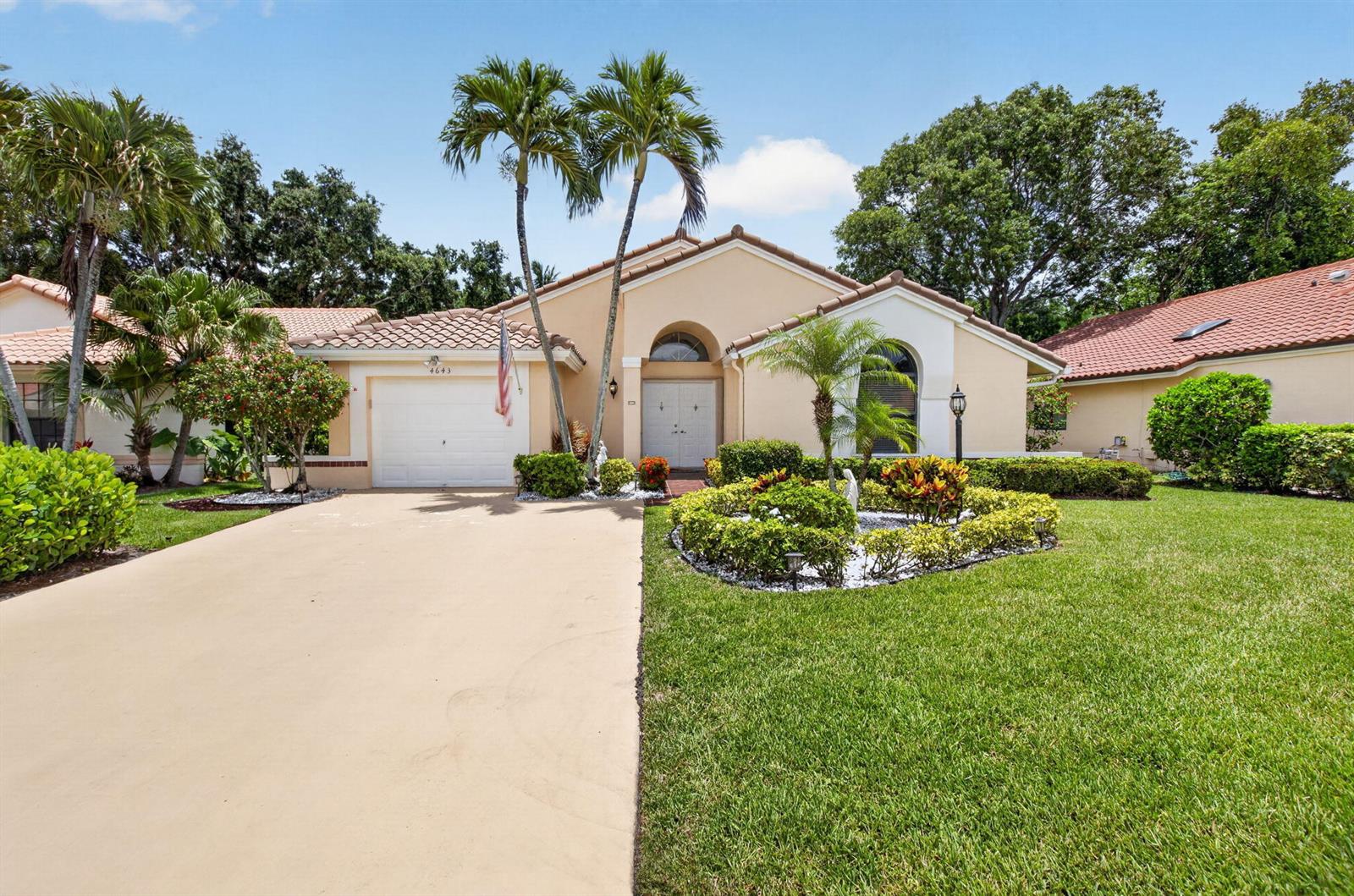 A single-story house with a beige stucco exterior, a tile roof, and a paved driveway — 4643 Sextant Circle, Boynton Beach FL 33436, BOYNTON BEACH, FL