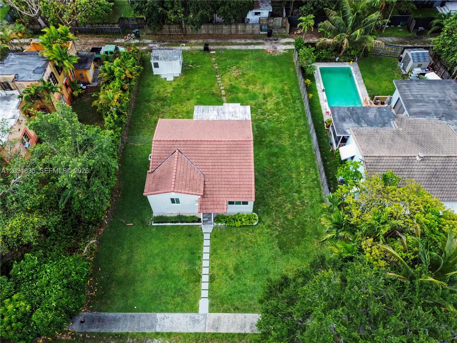 An aerial view shows a house with a red tile roof and a large backyard — 436 Lark Ave, Miami Springs FL 33166, MIAMI SPRINGS, FL